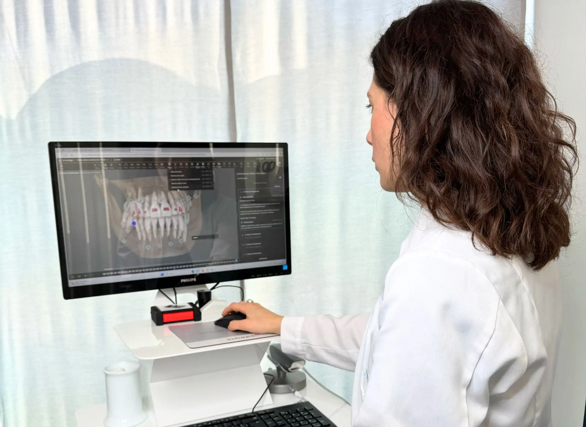 Dentista vicino a Verolanuova: Facchinetti Dental a Manerbio 2 Odontoiatra di Facchinetti Dental a Manerbio che studia al computer un piano di cura ortodontico digitale